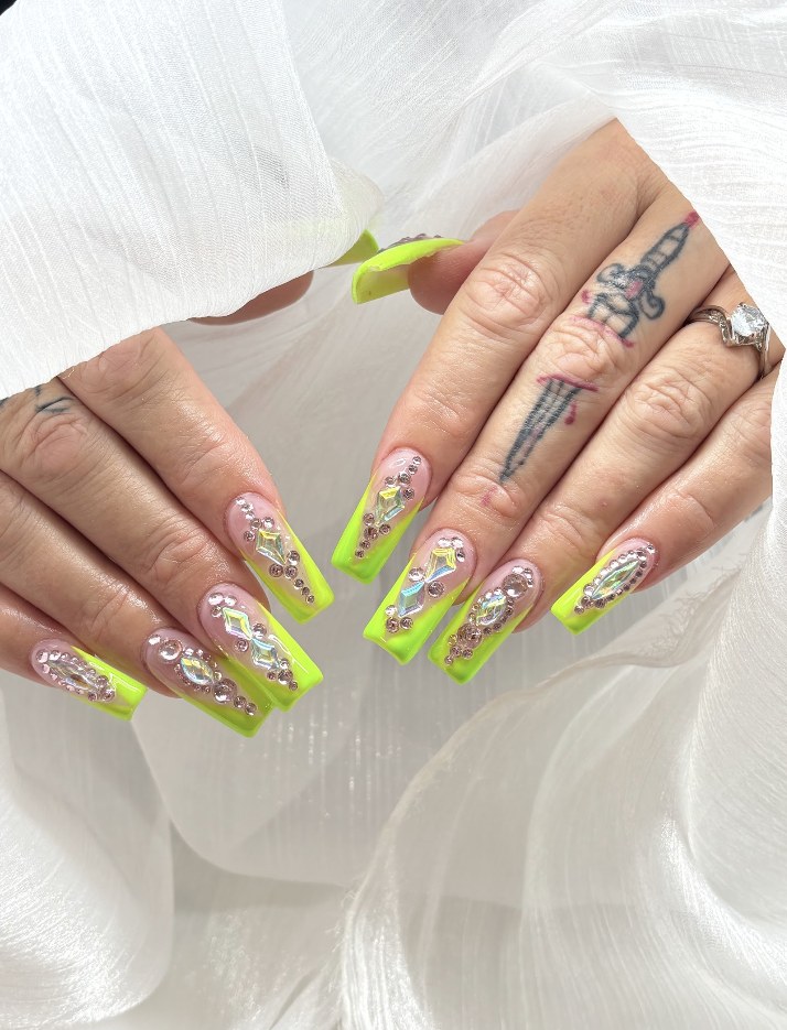 Neon green French manicure with ornate crystals