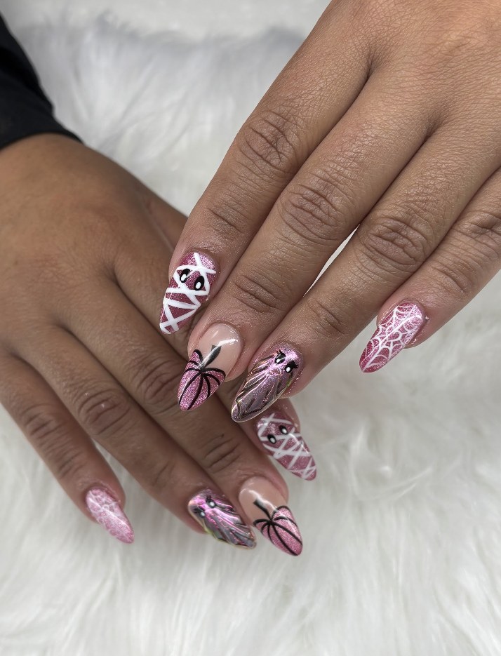 Pink pointed nails with spiderweb nail art