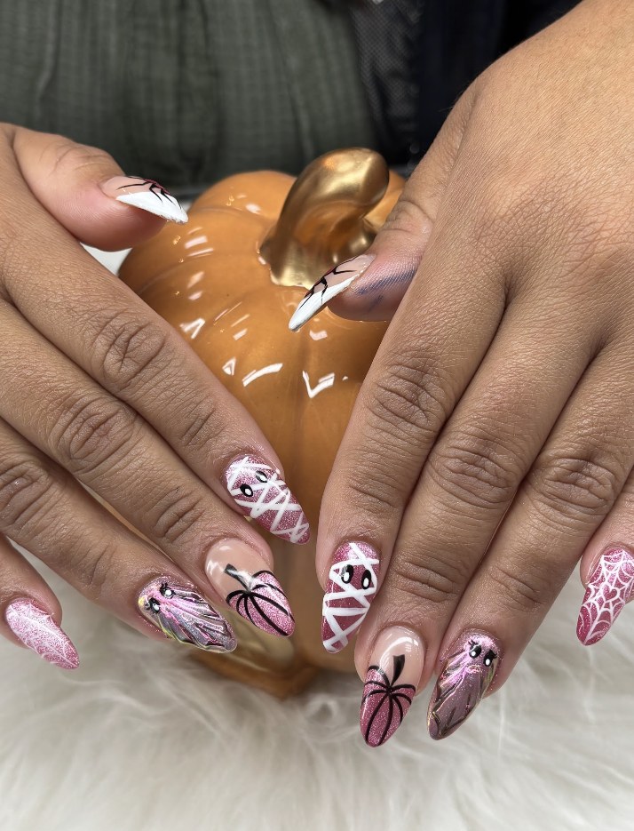 Pink Halloween nails with spider and web designs