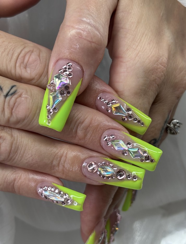 Long neon green nails with silver crystal details