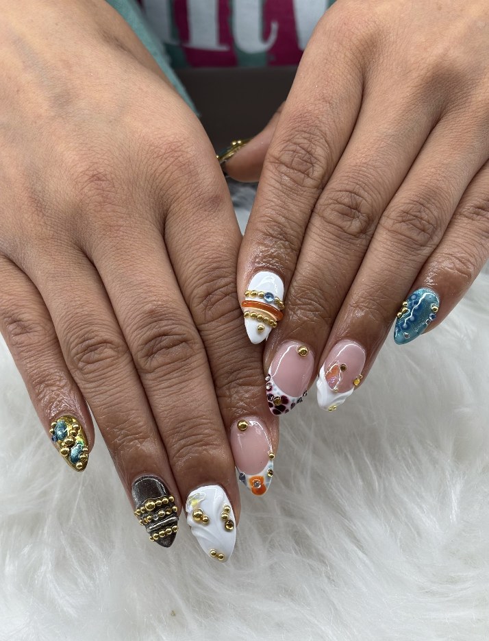 Mixed teal glitter and nude nails with gold details