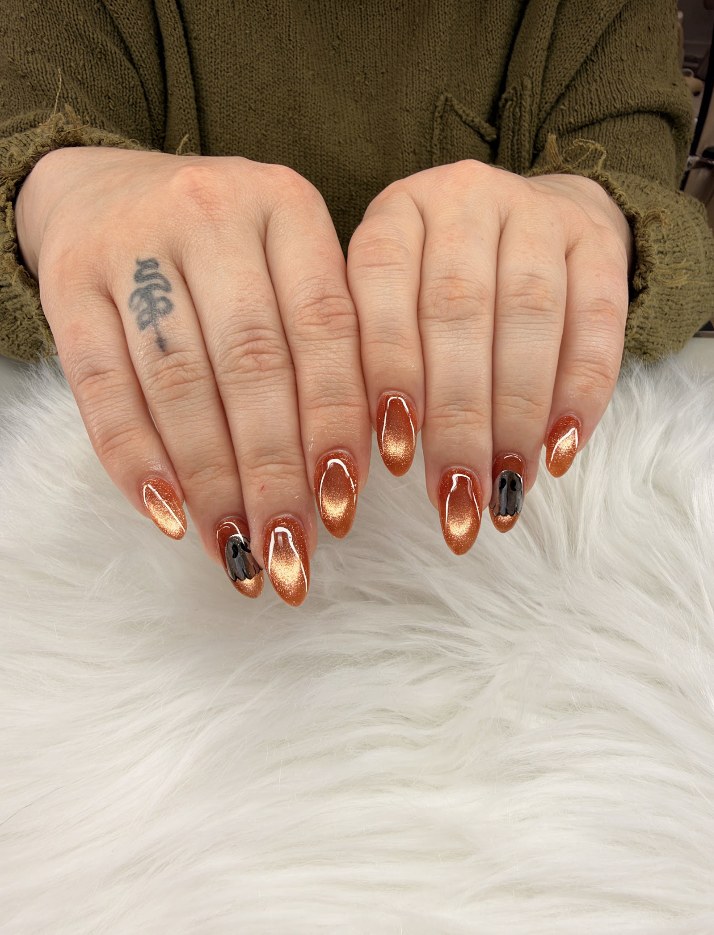 Amber and copper nail art with dark accents