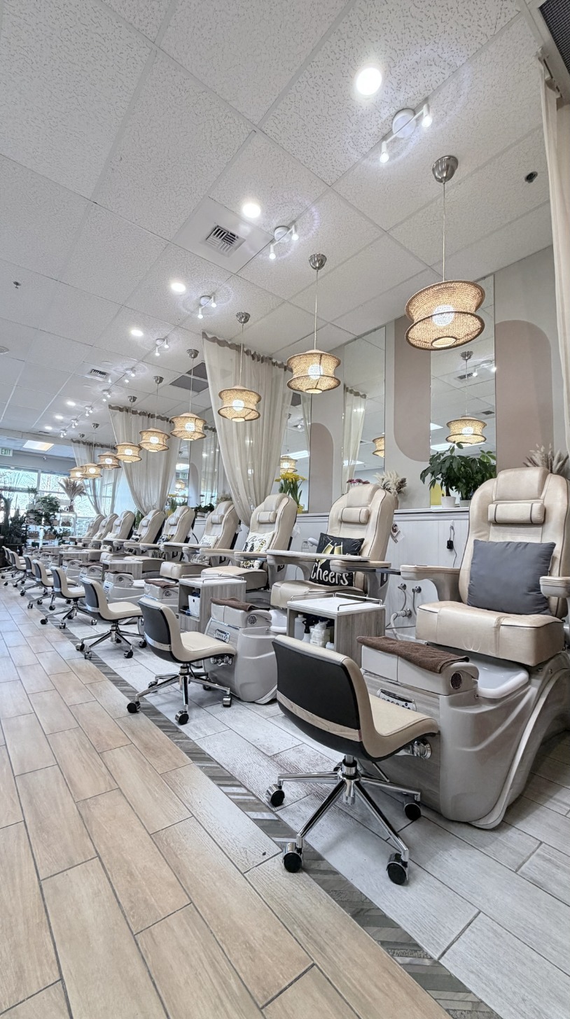 Pedicure chairs beneath woven pendant lights inside Darling Nails & Spa